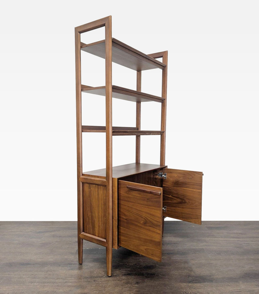 Modern bookshelf in rich walnut finish featuring open shelving and a spacious cabinet, perfect for organization.