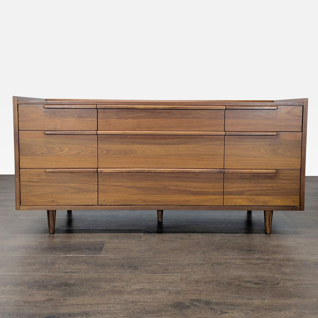 Sleek Crate & Barrel walnut dresser with nine drawers and mid-century modern style; ideal bedroom storage.