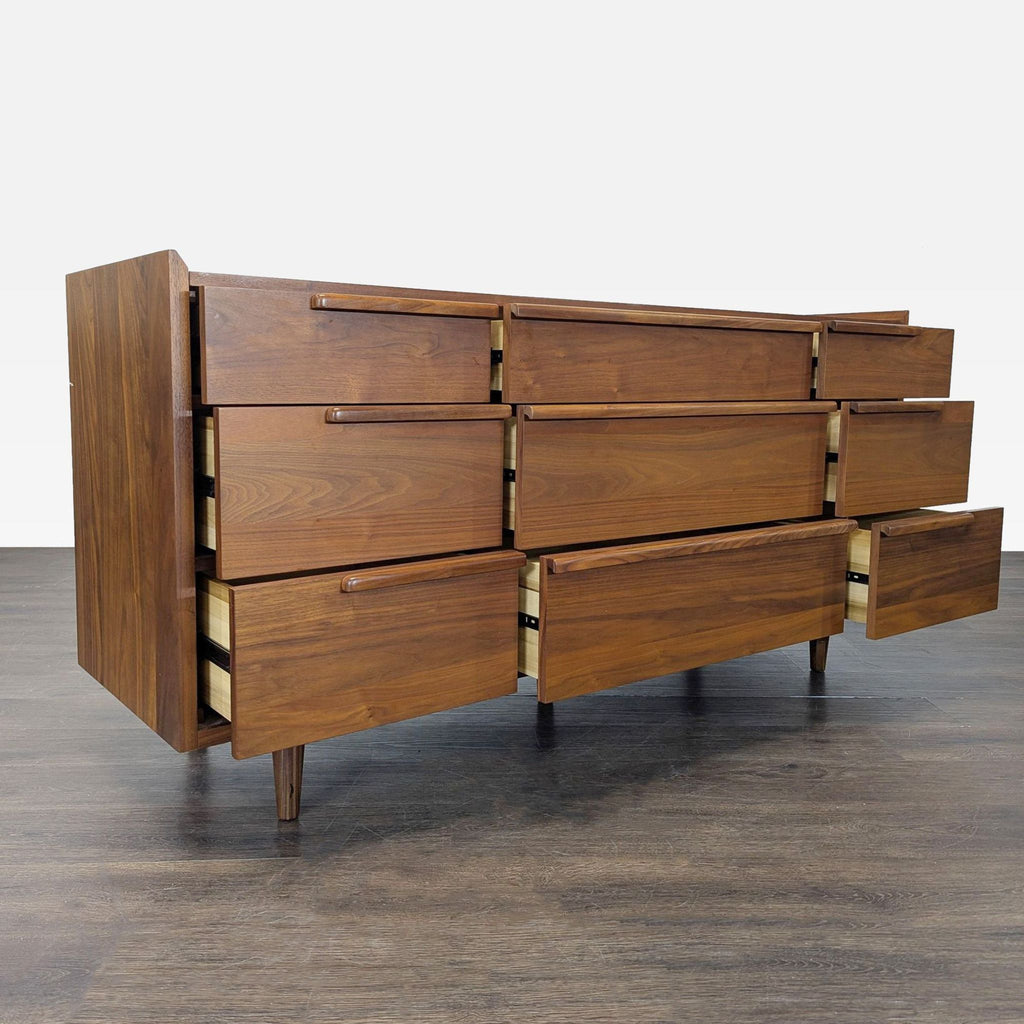 Mid-century modern dresser by Crate & Barrel, featuring spacious drawers and a smooth walnut finish.