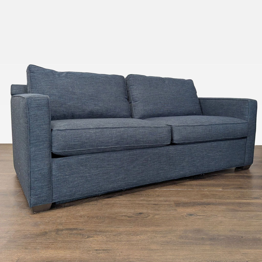 Modern sleeper sofa by Crate & Barrel in blue fabric, featuring supportive armrests and versatile style for any space.