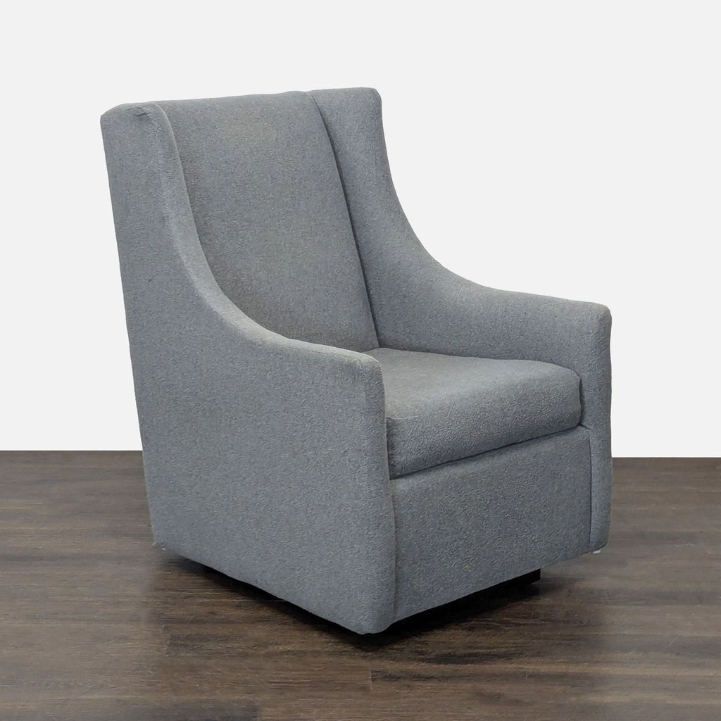 Modern West Elm rocking lounge chair in soft gray fabric, featuring a sturdy build and minimalist style.