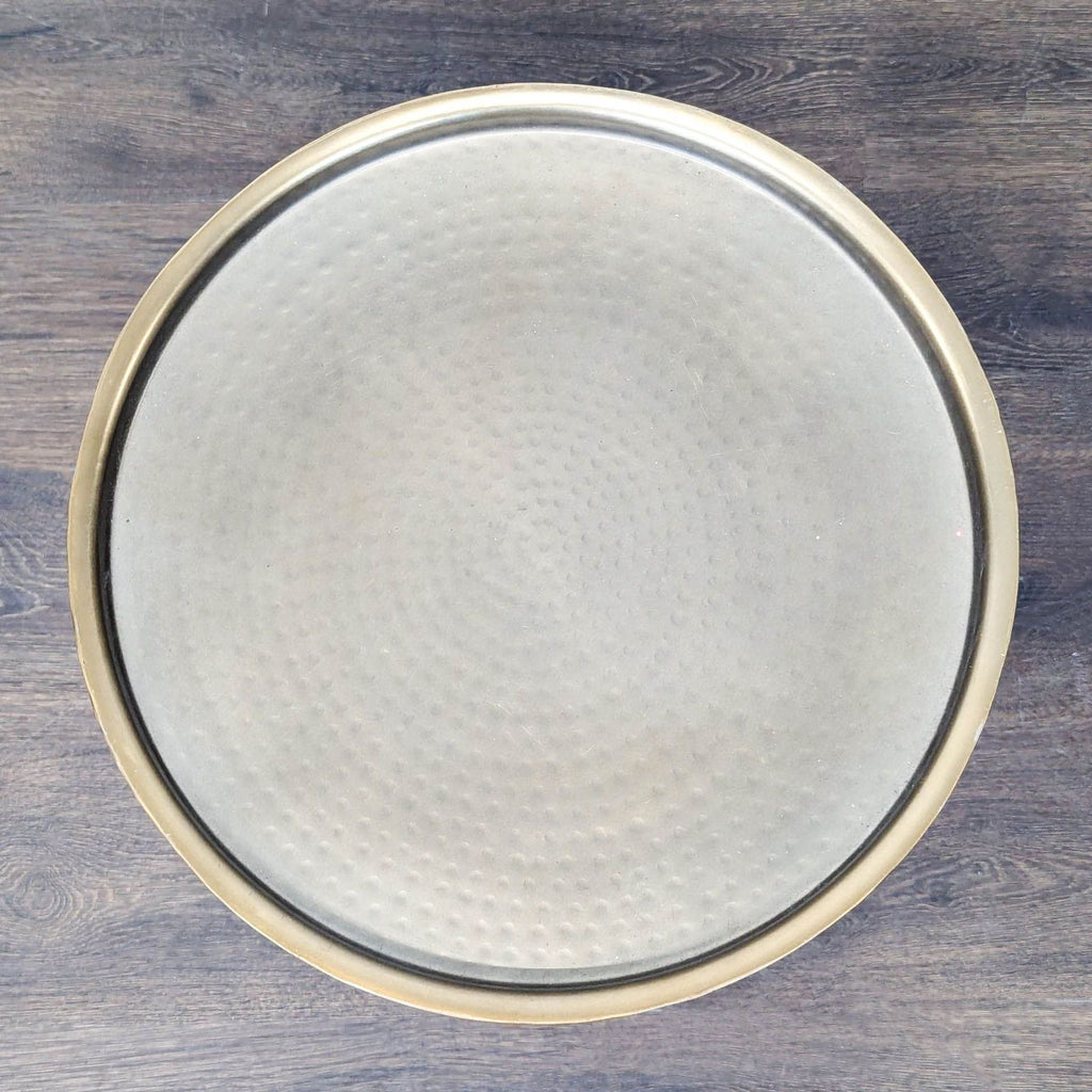 Modern hammered metal table with a round raised-edge top, categorized as a side table from Project 62.