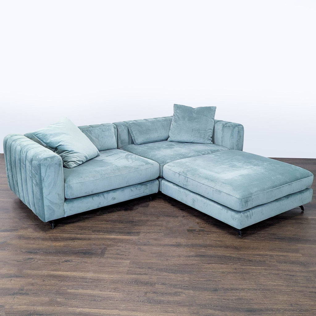 Modern Rove Concepts sectional, upholstered in light blue velvet, featuring a large ottoman and cozy seating.