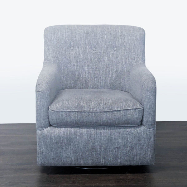 Modern grey lounge chair with plush cushion, button-back design, and swivel base, ideal for relaxing spaces.