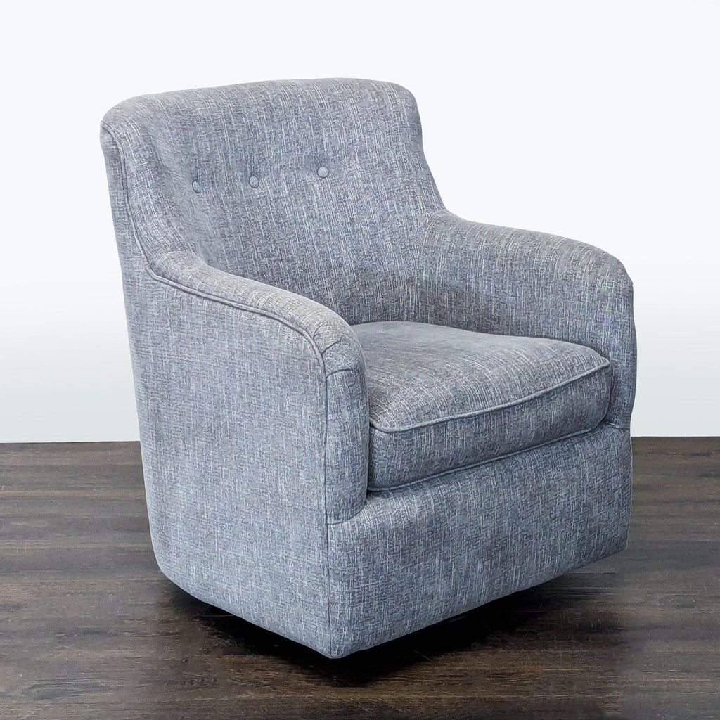 Stylish grey swivel lounge chair with soft fabric, featuring a classic button-back and comfortable seating.
