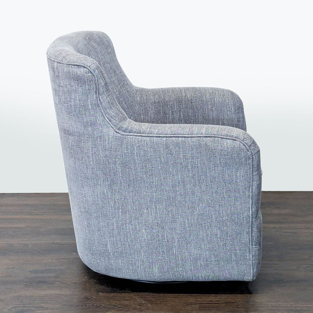 Comfortable grey lounge chair with a swivel base, padded seat, and versatile design to suit various interiors.