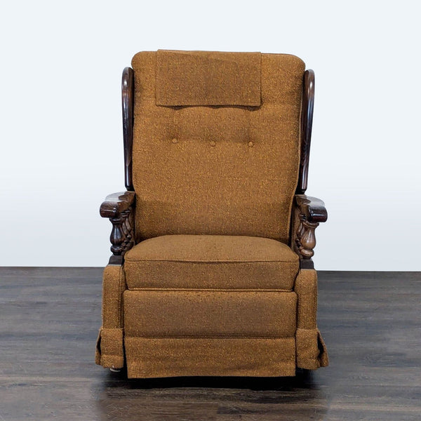 Vintage brown lounge chair with button-tufted back, carved wood armrests, and fold-out footrest.  