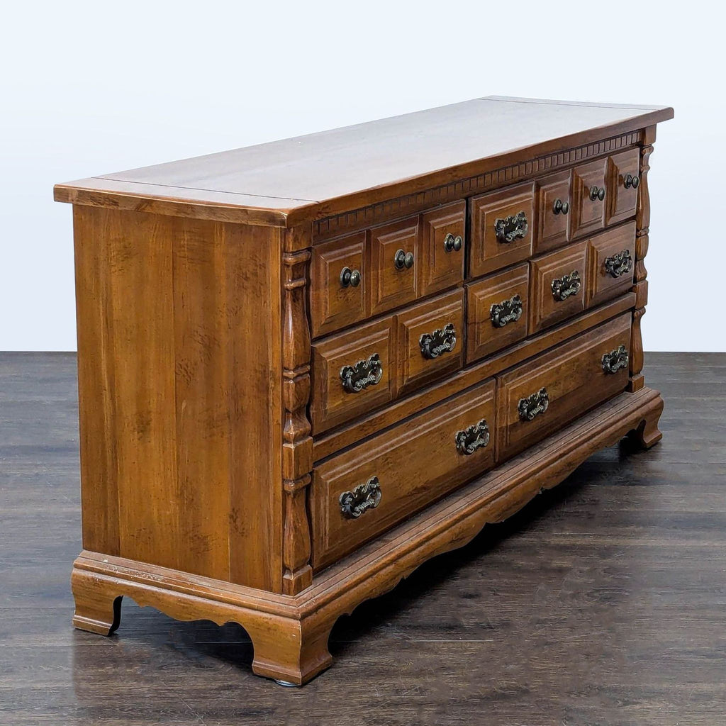 Angled view of Sumter dresser, featuring sturdy wood construction and nine drawers with vintage brass pulls.