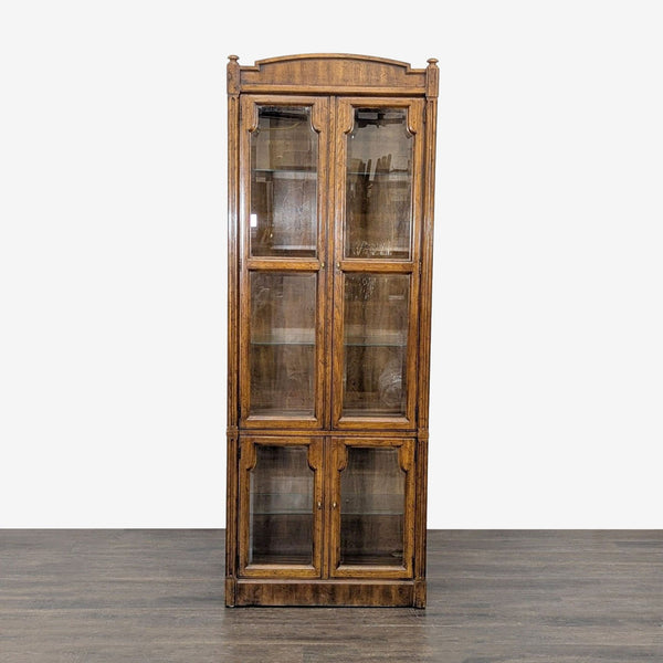 Drexel Heritage wood cabinet featuring four doors, glass shelving, and transparent glass front and sides.
