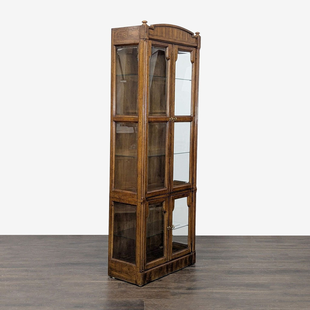 Elegant cabinet with wooden frame, four doors, glass shelves, and clear glass panels on front and sides.