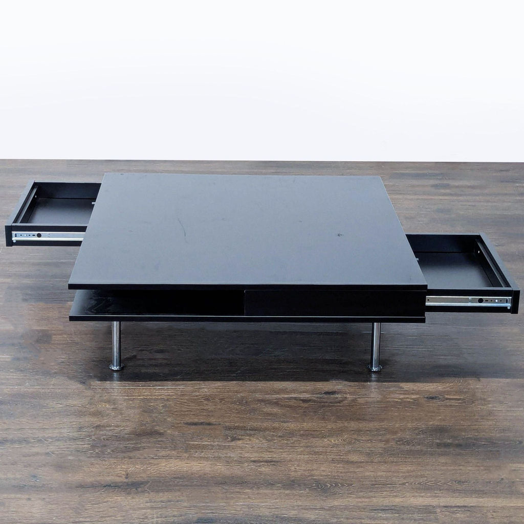 Modern black coffee table by IKEA featuring a glossy finish, two storage drawers, and a lower shelf.  