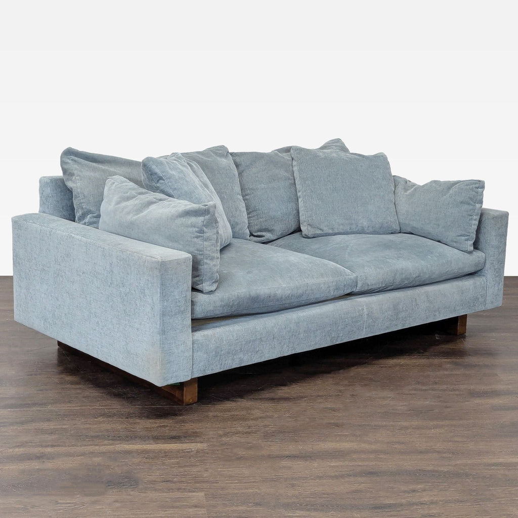 Ocean-colored West Elm 3-seater sofa with soft down-blend cushions and rich walnut-finished base.  