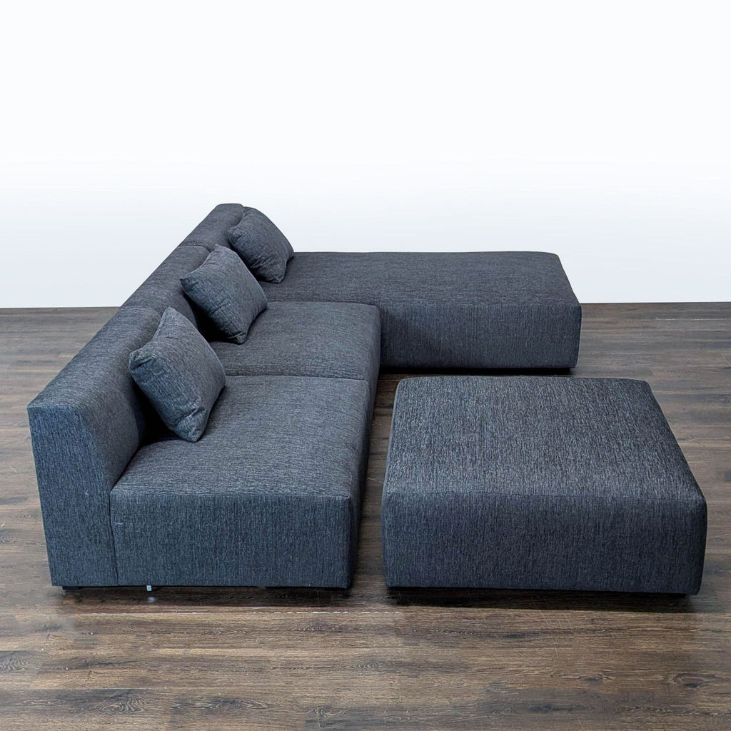 Spacious Maiden Home sectional with wide chaise, matching ottoman, and pillows; perfect for lounging and entertaining.