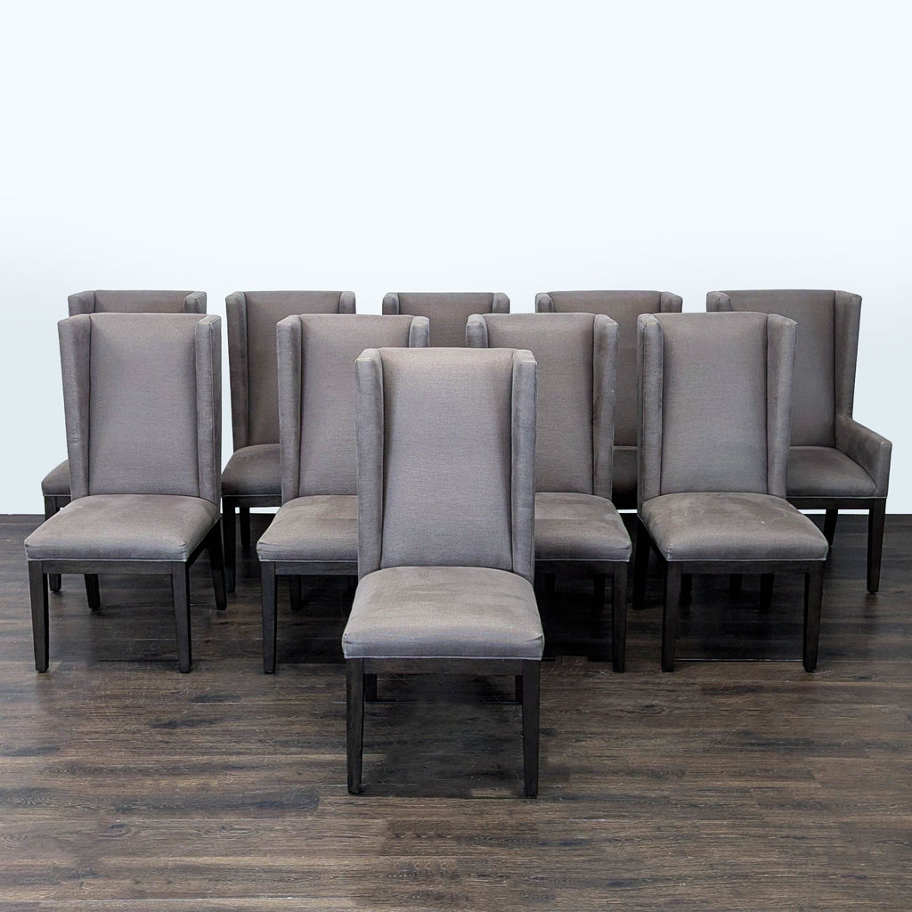 Restoration Hardware dining table and ten matching gray upholstered chairs, combining comfort and timeless style.