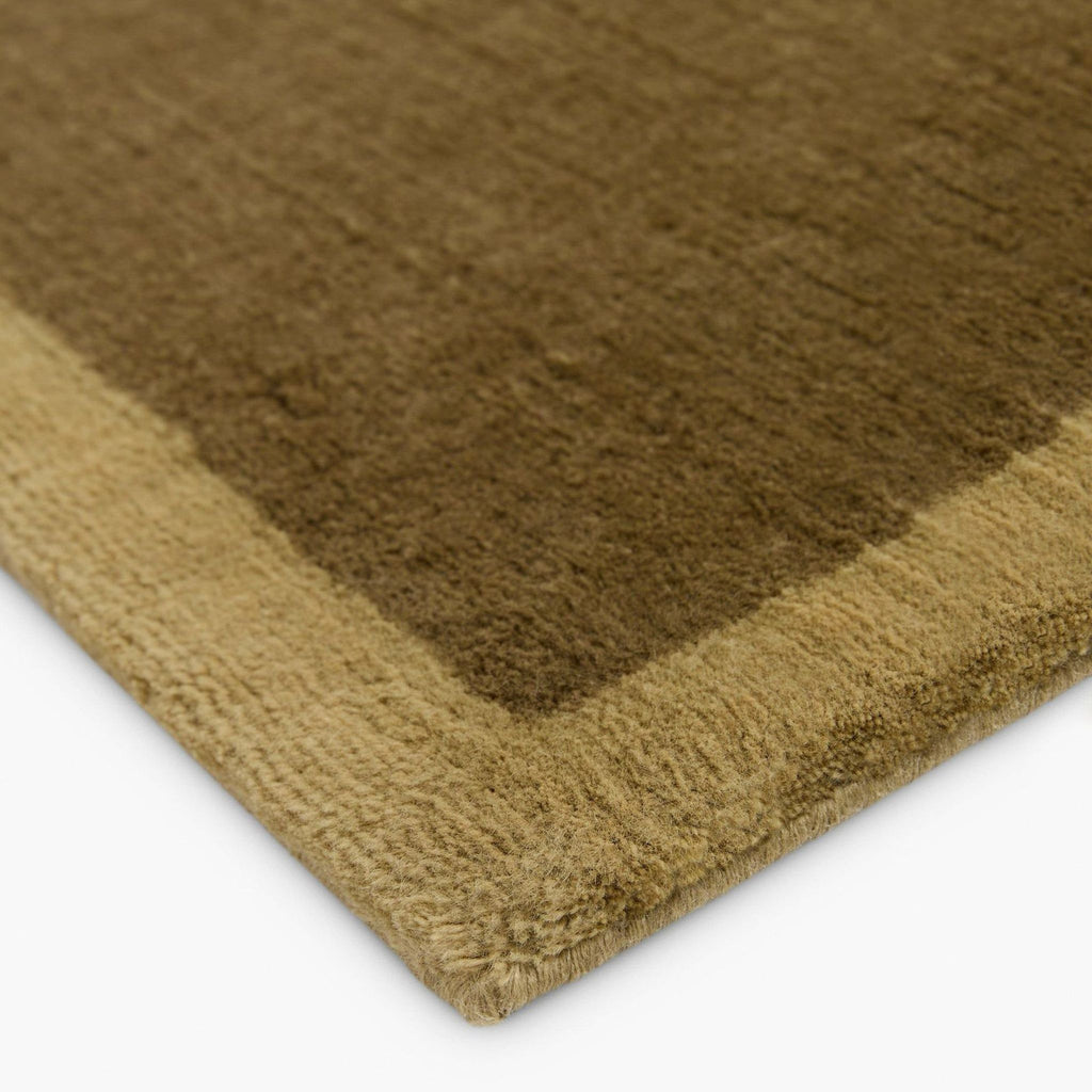 Modern wool rug by Lulu and Georgia featuring a beige center framed by a bold brown border.  