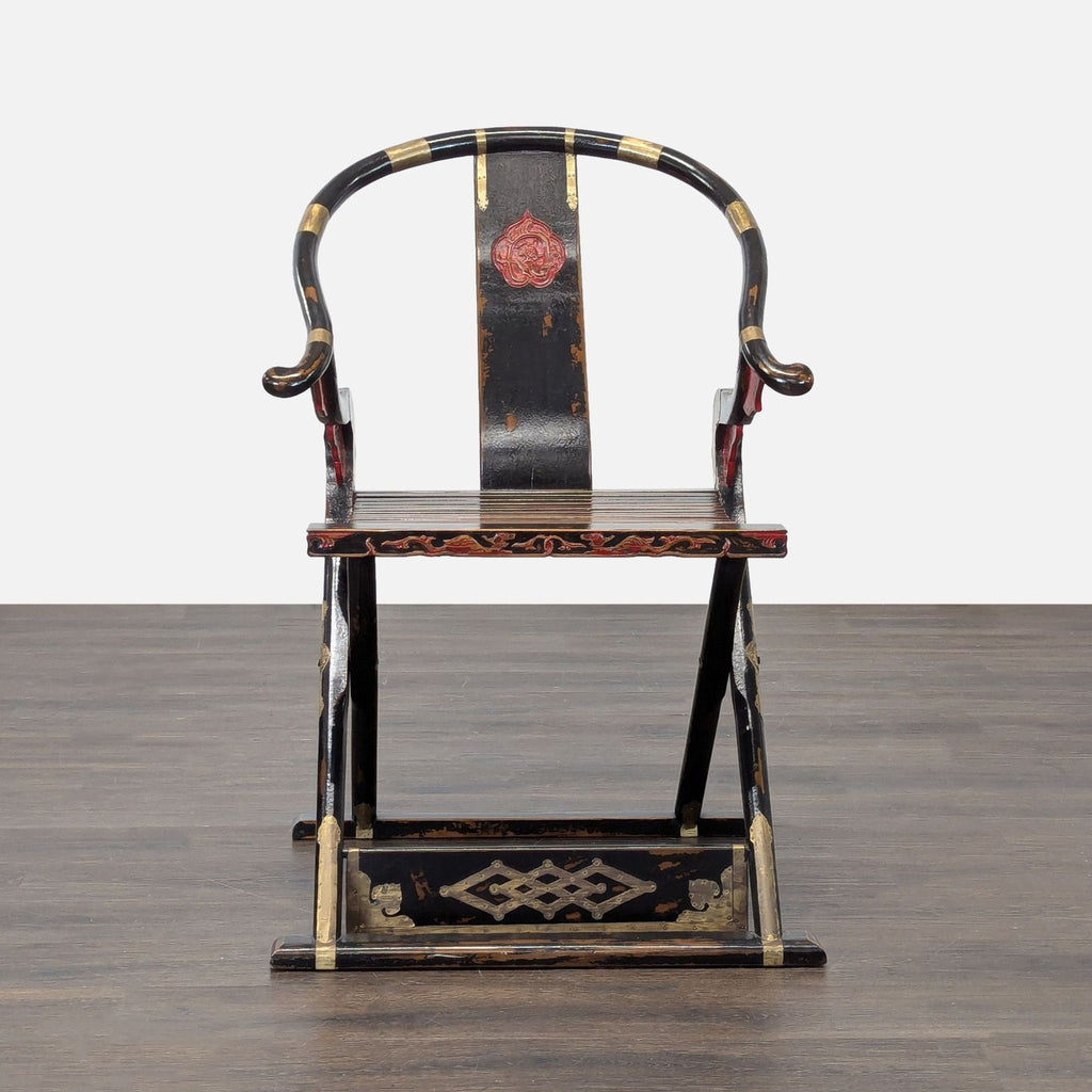 Vintage Chinese folding lounge chair with a horseshoe back and ornate red and gold accents.