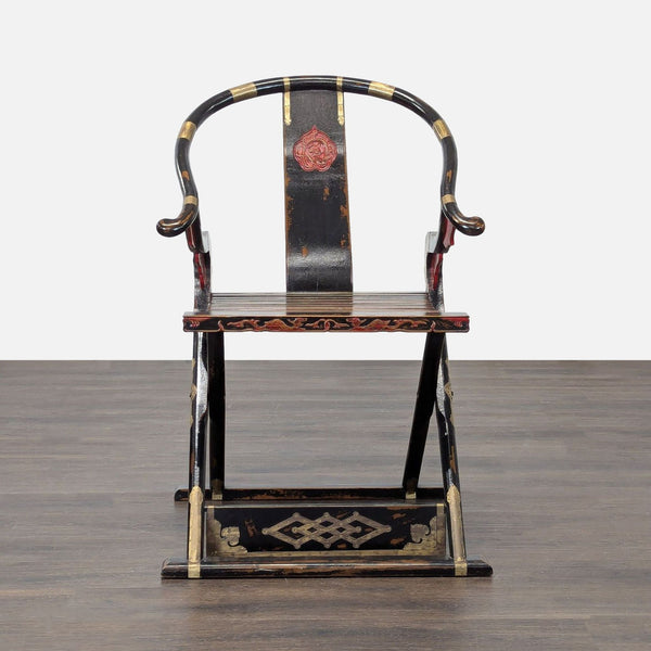 Vintage Chinese folding lounge chair with a horseshoe back and ornate red and gold accents.