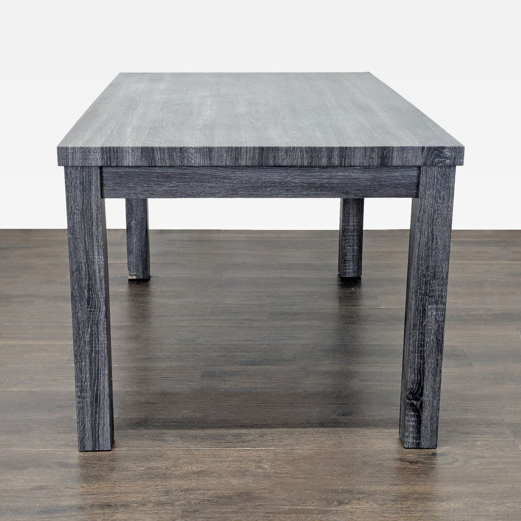 Dining set by Gracie Oaks with gray table and comfy beige chairs, suitable for family meals or gatherings.