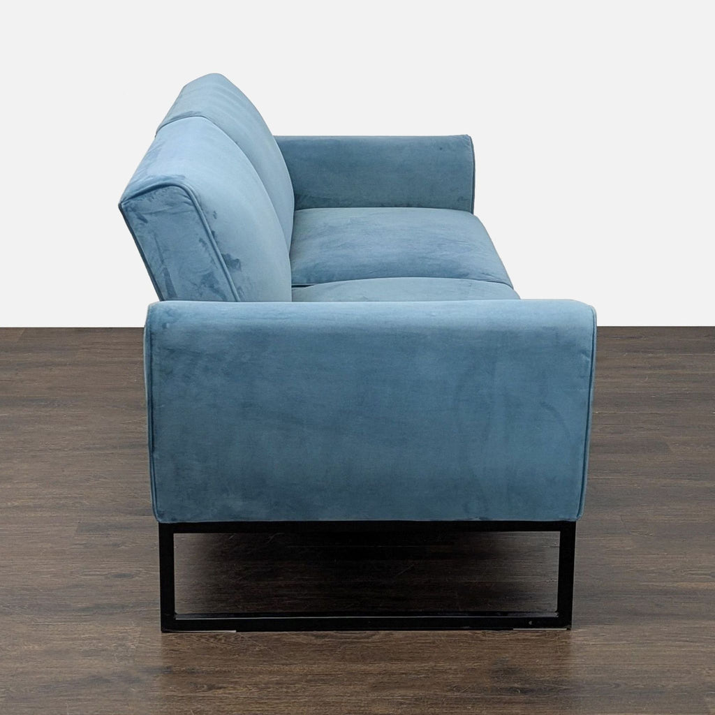 Convertible blue upholstered sofa, seating three, by Dorel Home Furnishings, featuring a sleek black metal frame.