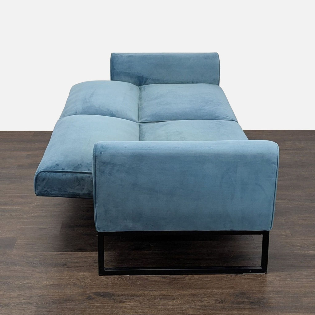 Modern 3-seat blue sofa with black metal base from Dorel Home Furnishings, easily transforms into a bed.
