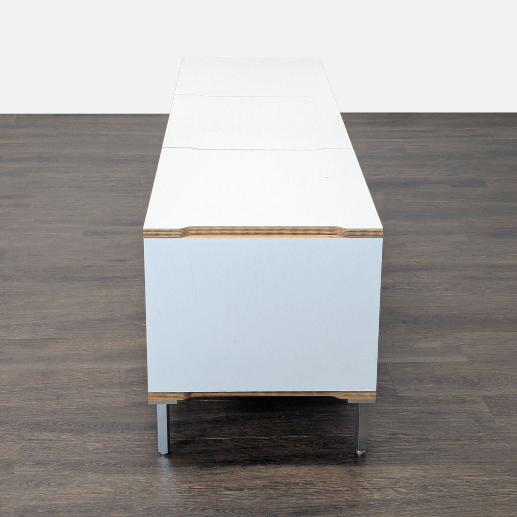 Contemporary cabinet by Scandinavian Designs; white with wood accents, metal legs, and loose left cabinet lock.