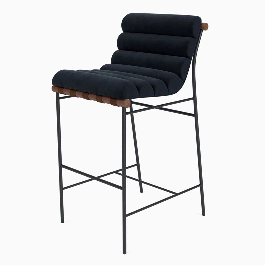 Modern stool featuring solid wood dowel, leather strap accents, upholstered seat, and powder-coated steel base.