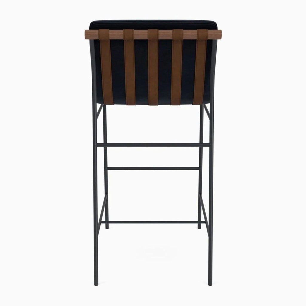 Contemporary Denver Modern stool with tufted fabric, wood detailing, leather straps, and black steel legs.