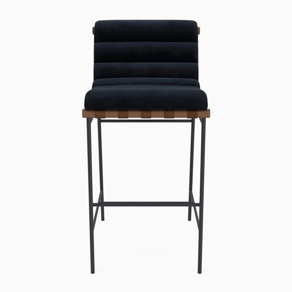 Denver Modern stool with channel-tufted upholstery, wood dowel, leather straps, and a steel frame.