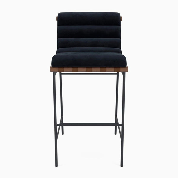 Denver Modern stool with channel-tufted upholstery, wood dowel, leather straps, and a steel frame.