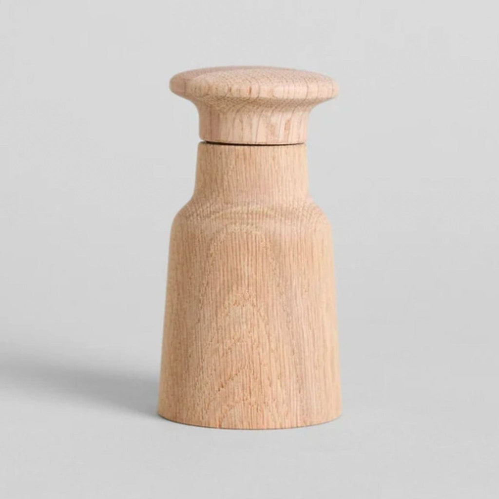 Natural oak wood grinder by Fritz Hansen, with a simple, modern Scandinavian design for salt or pepper grinding.