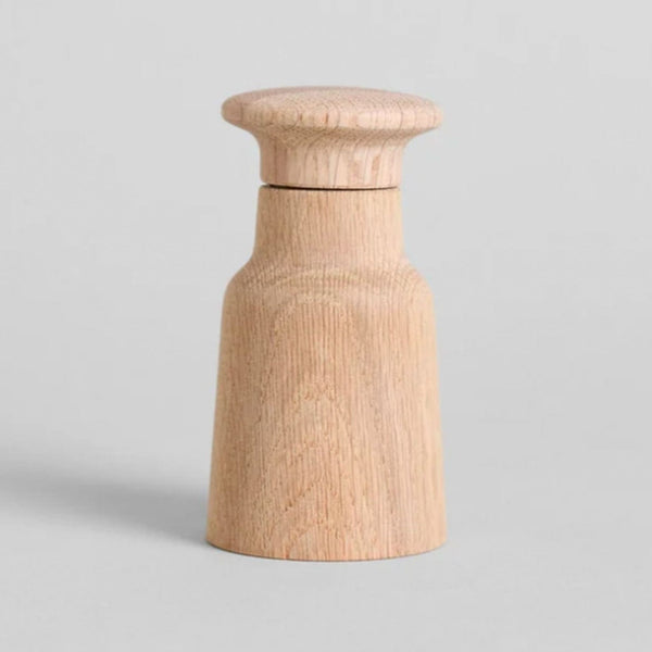 Natural oak wood grinder by Fritz Hansen, with a simple, modern Scandinavian design for salt or pepper grinding.
