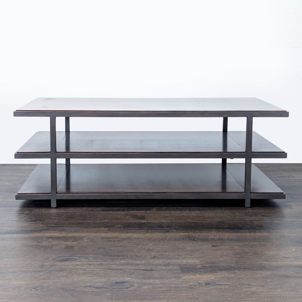 Restoration Hardware coffee table with wood shelves and a sturdy metal frame.