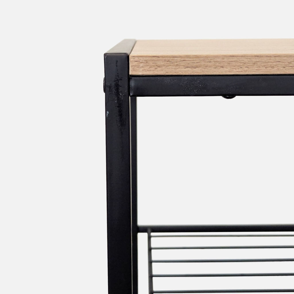 3. Close-up of the corner of a black metal shelf frame with a light wood top, highlighting material detail.
