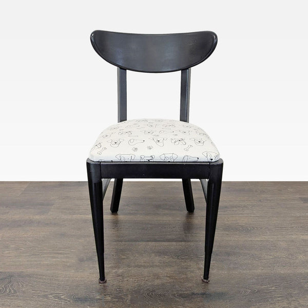 Mid-century dining chair featuring playful dog print upholstery.