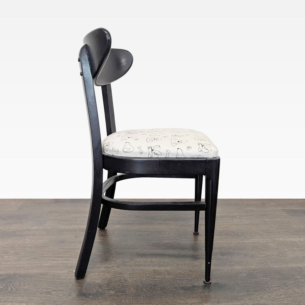 Vintage-inspired dining chair with a dog-patterned fabric seat and back.