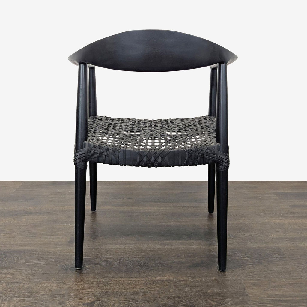 Safavieh Home dining chair made from black-finished teak and woven genuine black leather seat.