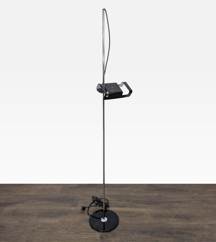 Modern Joe Colombo for Oluce floor lamp featuring a sleek chrome pole, round black base, and unique adjustable lamp.