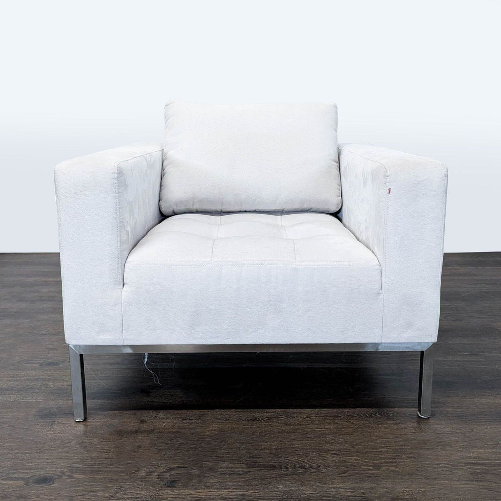 1. Modern white lounge chair with soft cushion, squared arms, and metal legs, shown from the front on wood floor.