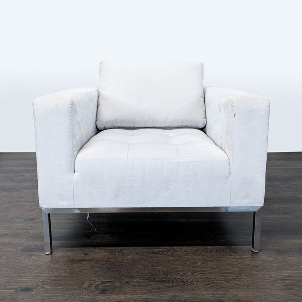 1. Modern white lounge chair with soft cushion, squared arms, and metal legs, shown from the front on wood floor.