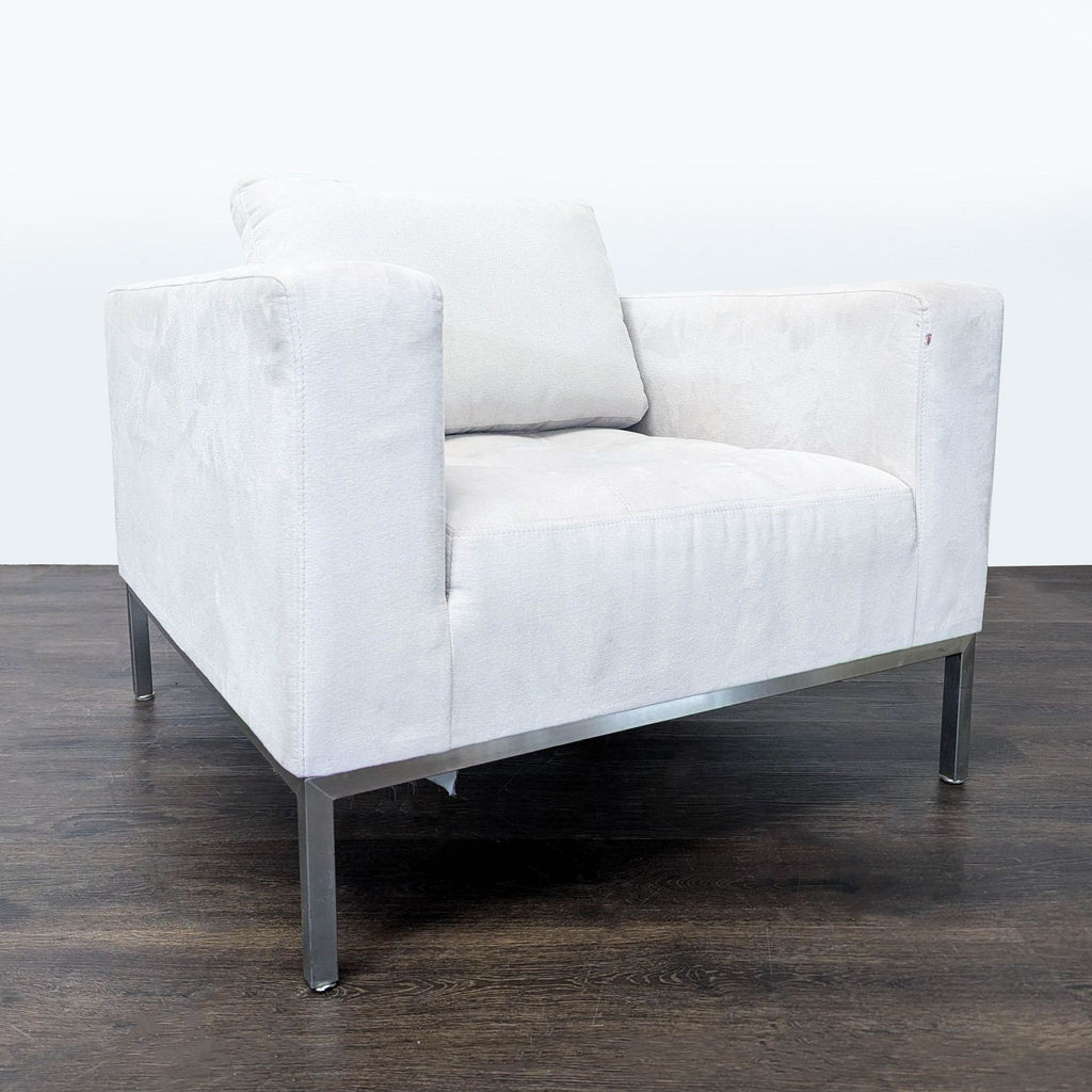 2. Contemporary white lounge chair with plush seat and metal legs, angled view highlighting squared arms and comfort.