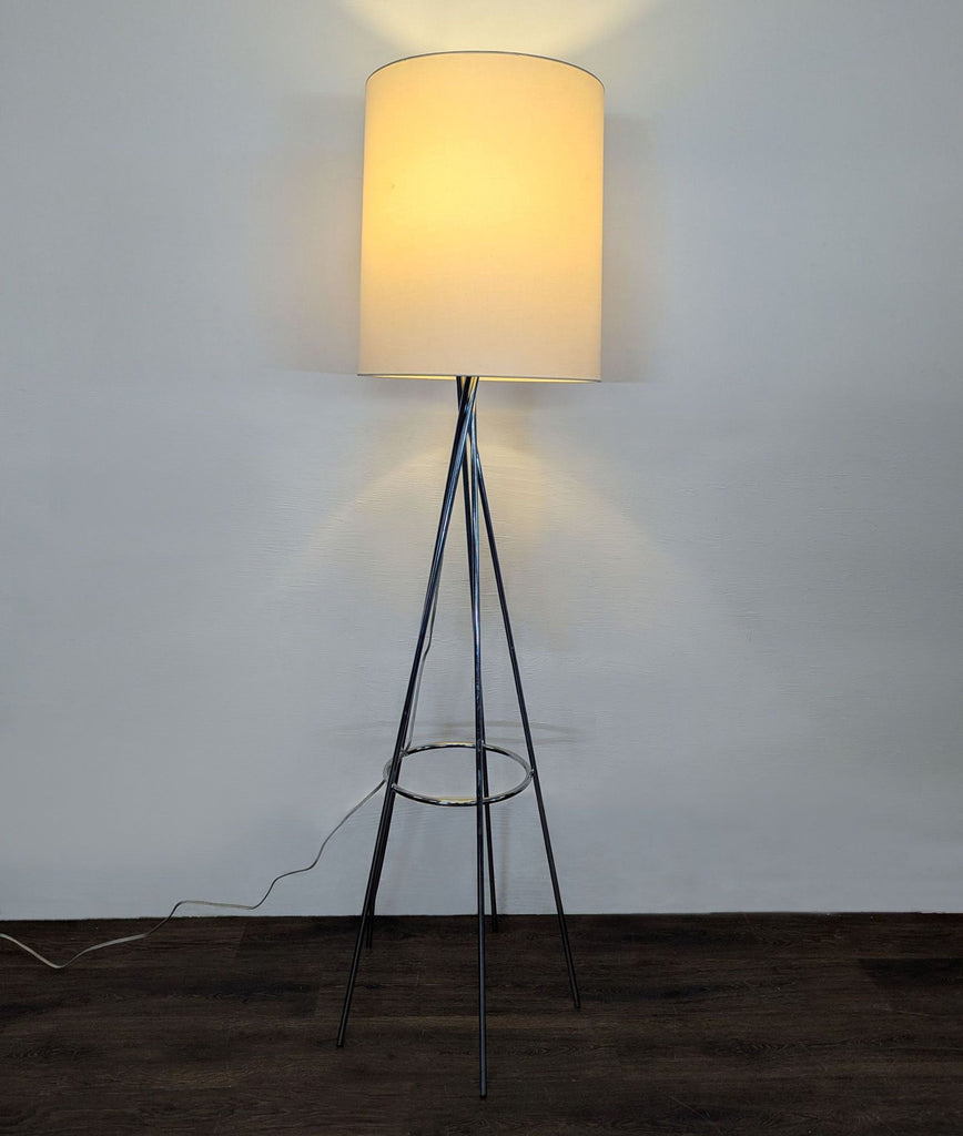 1. Modern floor lamp with a chrome tripod base and white cylinder shade, providing warm light for any room.  