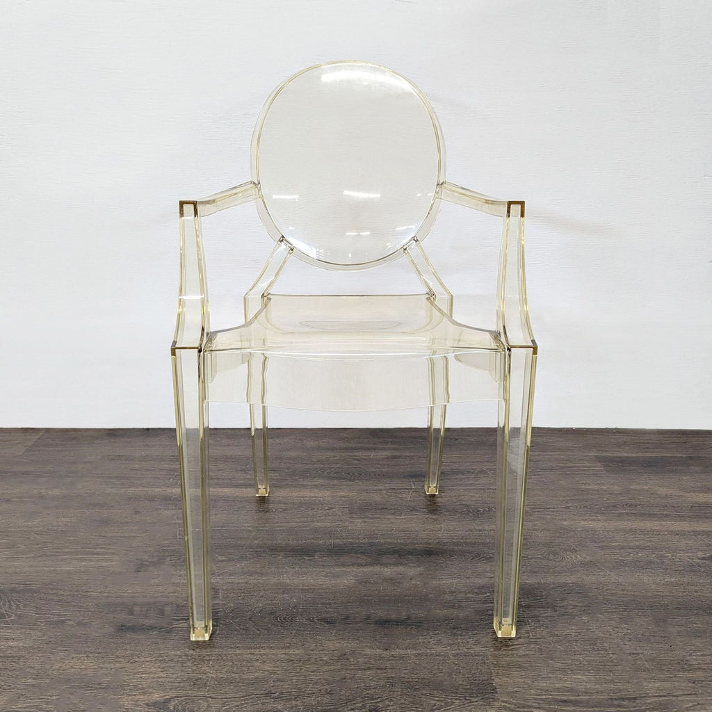 1. Transparent acrylic dining chair with rounded back and armrests, shown from the front on a dark floor.