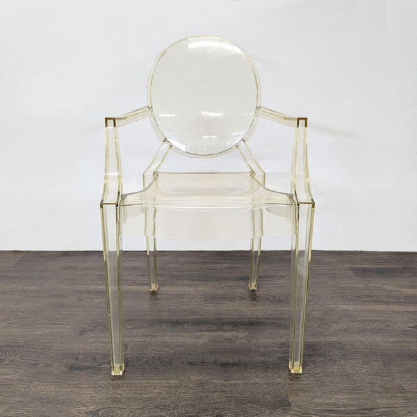 1. Transparent acrylic dining chair with rounded back and armrests, shown from the front on a dark floor.