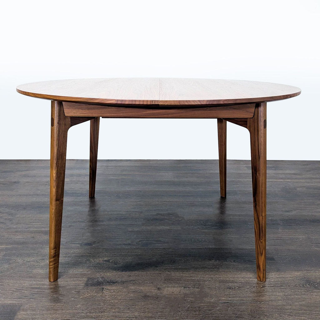 Matthew Hilton's Dulwich Extension Table for Case Furniture features slender walnut legs, mitered joints, and seats six.
