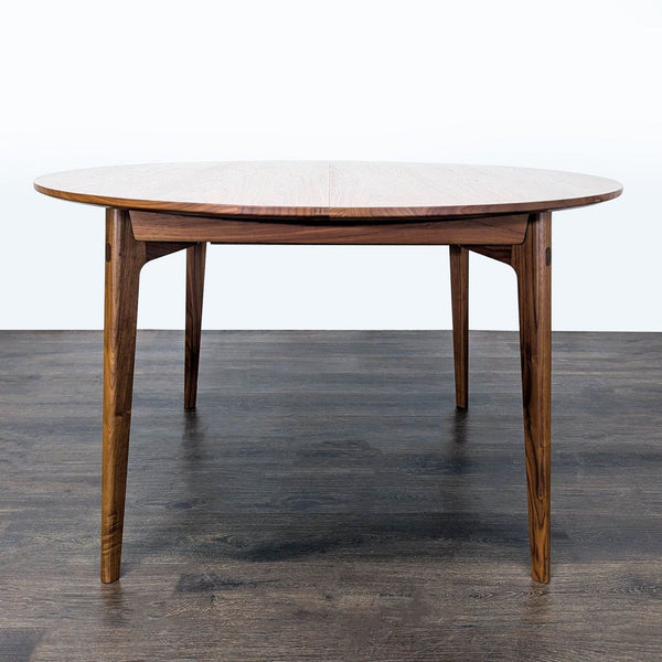 Matthew Hilton's Dulwich Extension Table for Case Furniture features slender walnut legs, mitered joints, and seats six.