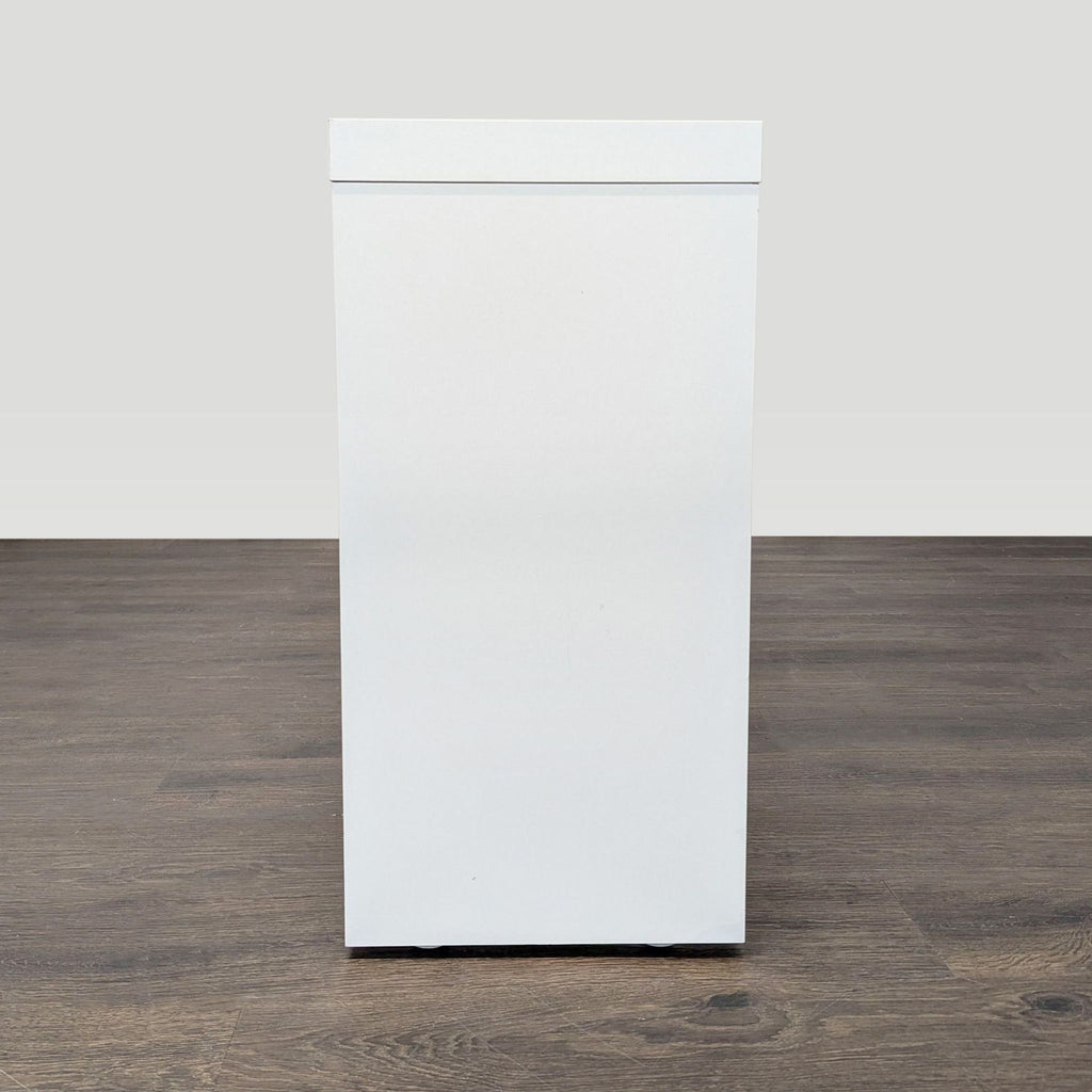 1. Minimalist white side table with a solid rectangular design, shown on a wooden floor with neutral background.