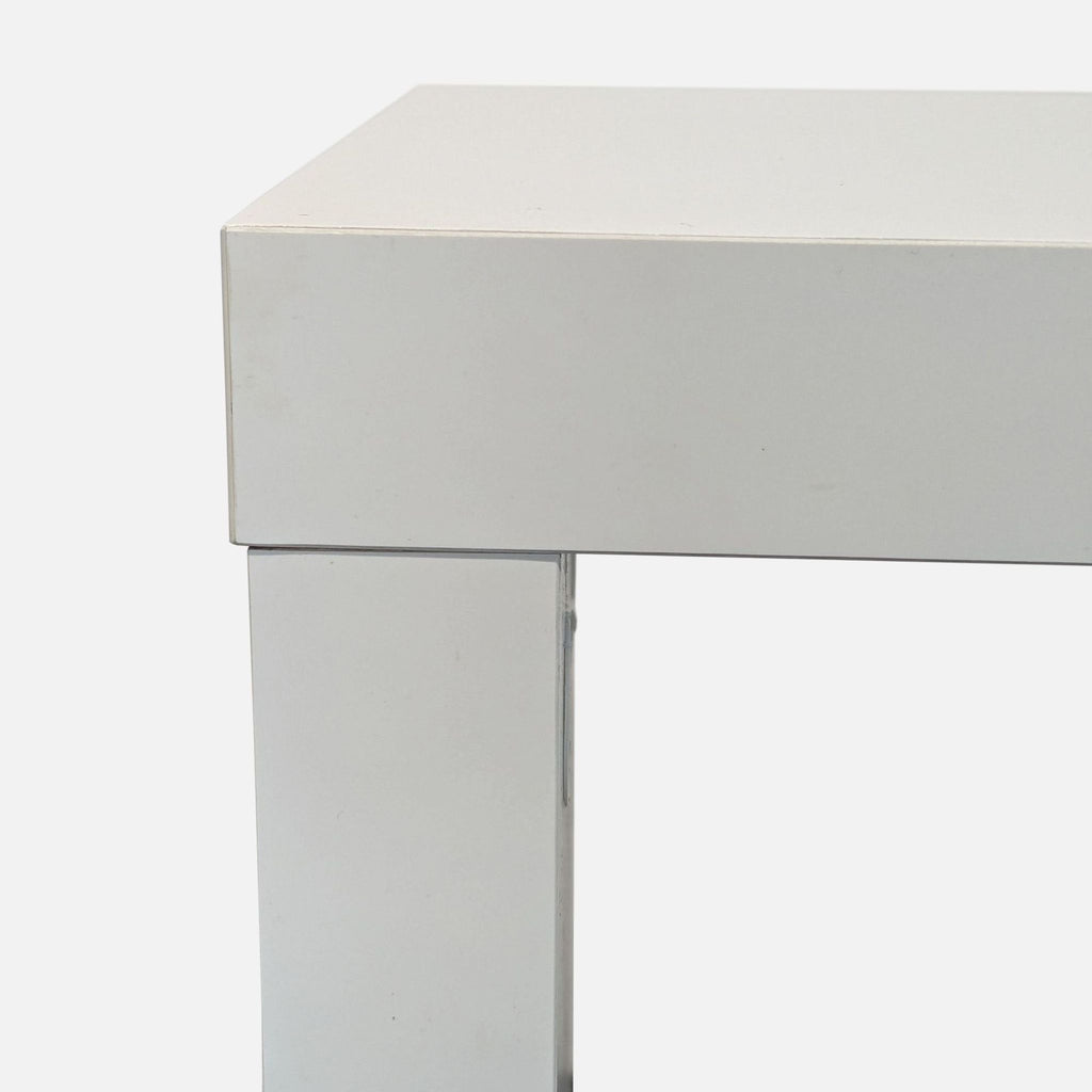 2. Close-up of a white console table corner, highlighting clean lines and smooth, modern surfaces.