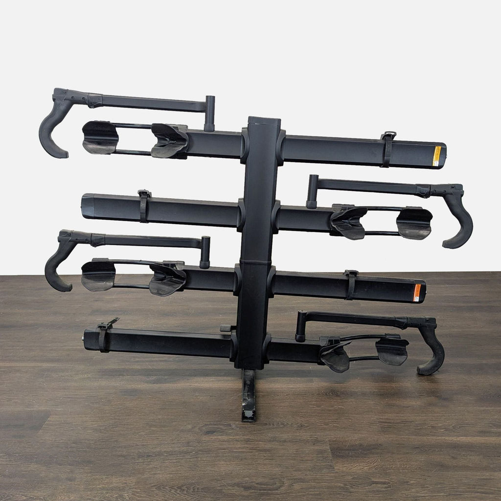 Kuat hitch-mounted bike rack for 4 bikes with adjustable arms, includes lock, fits most vehicles, good condition.