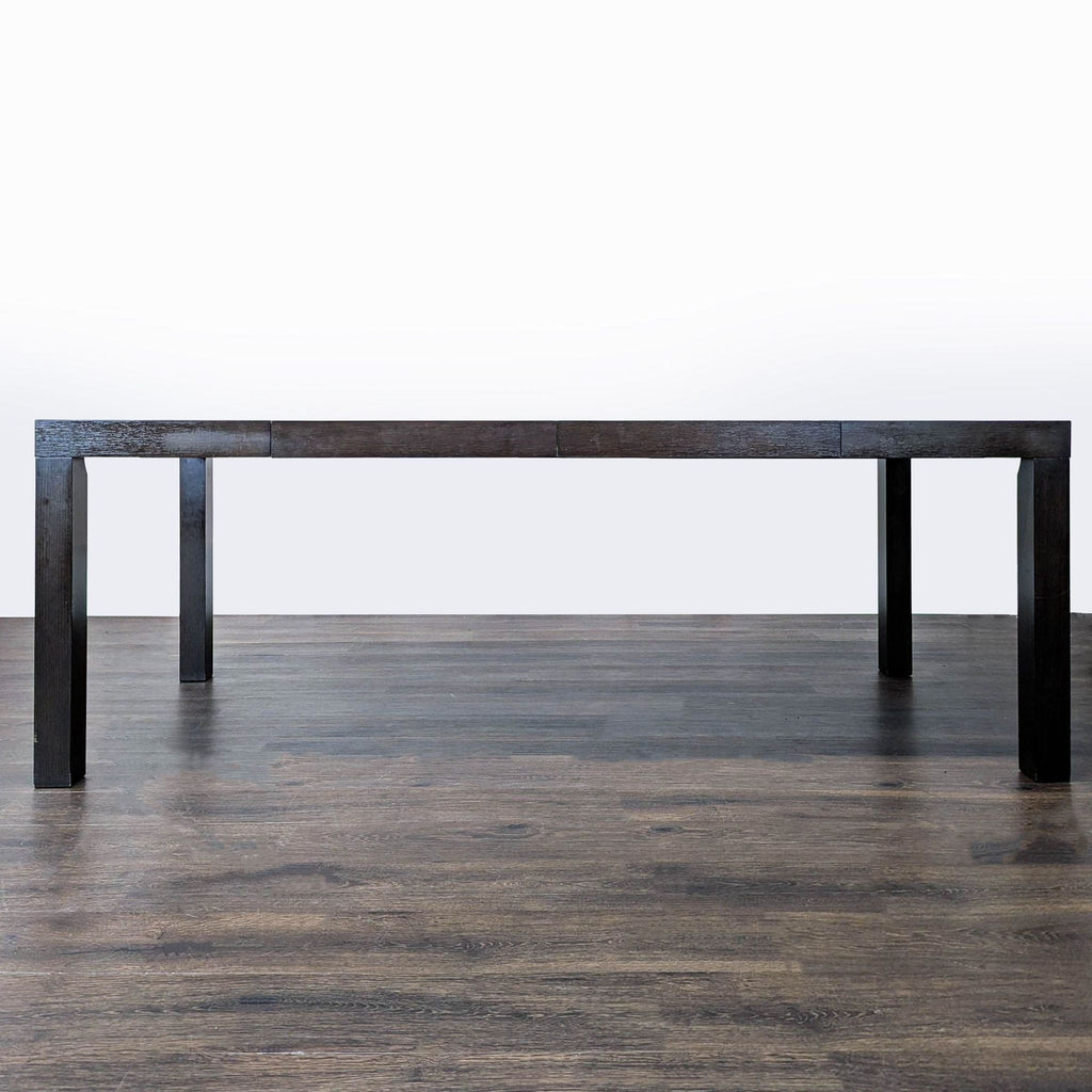 Contemporary West Elm dining table, Parsons style, features two removable leaves for extra space.