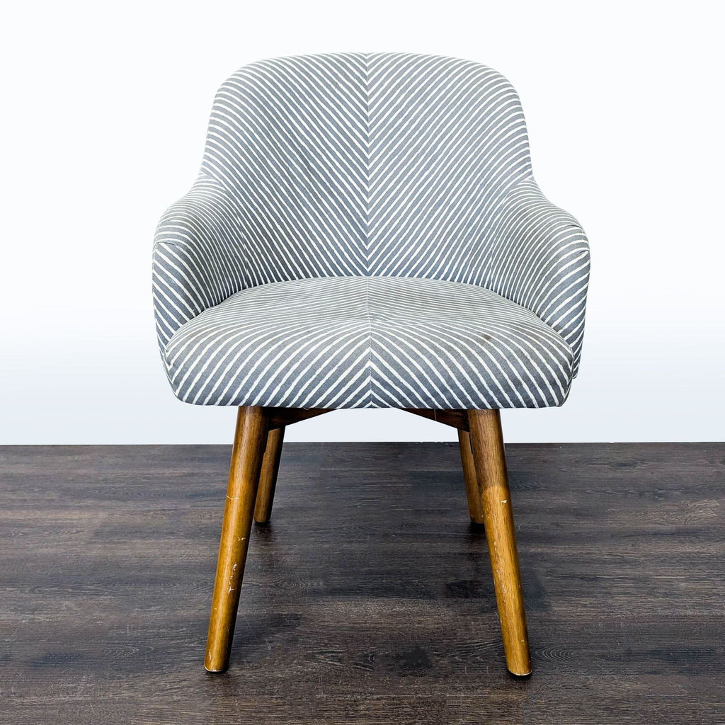 Grey and white striped lounge chair with curved back, wooden swivel legs, and modern West Elm style.